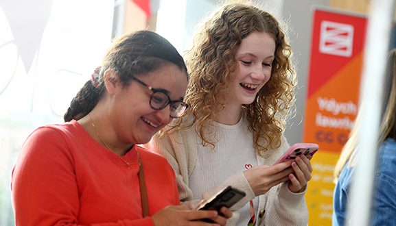 students smiling at phones