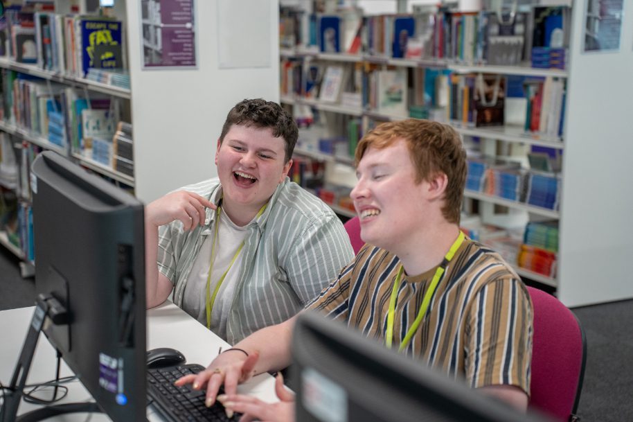 Students laughing whilst studying at TLZ library