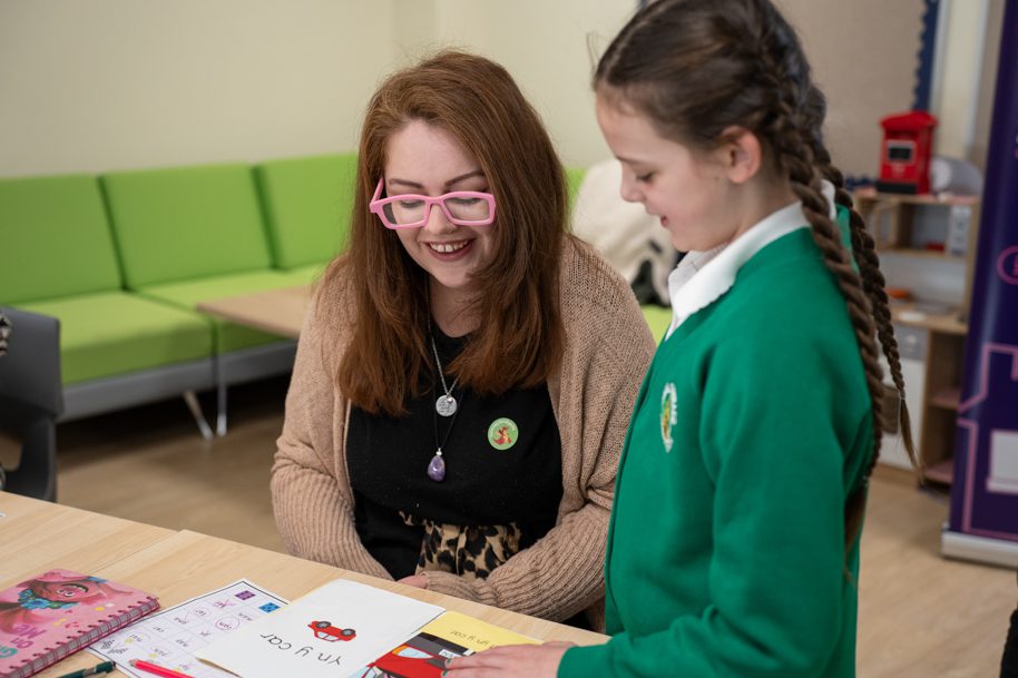 Parent learning Welsh with child at school