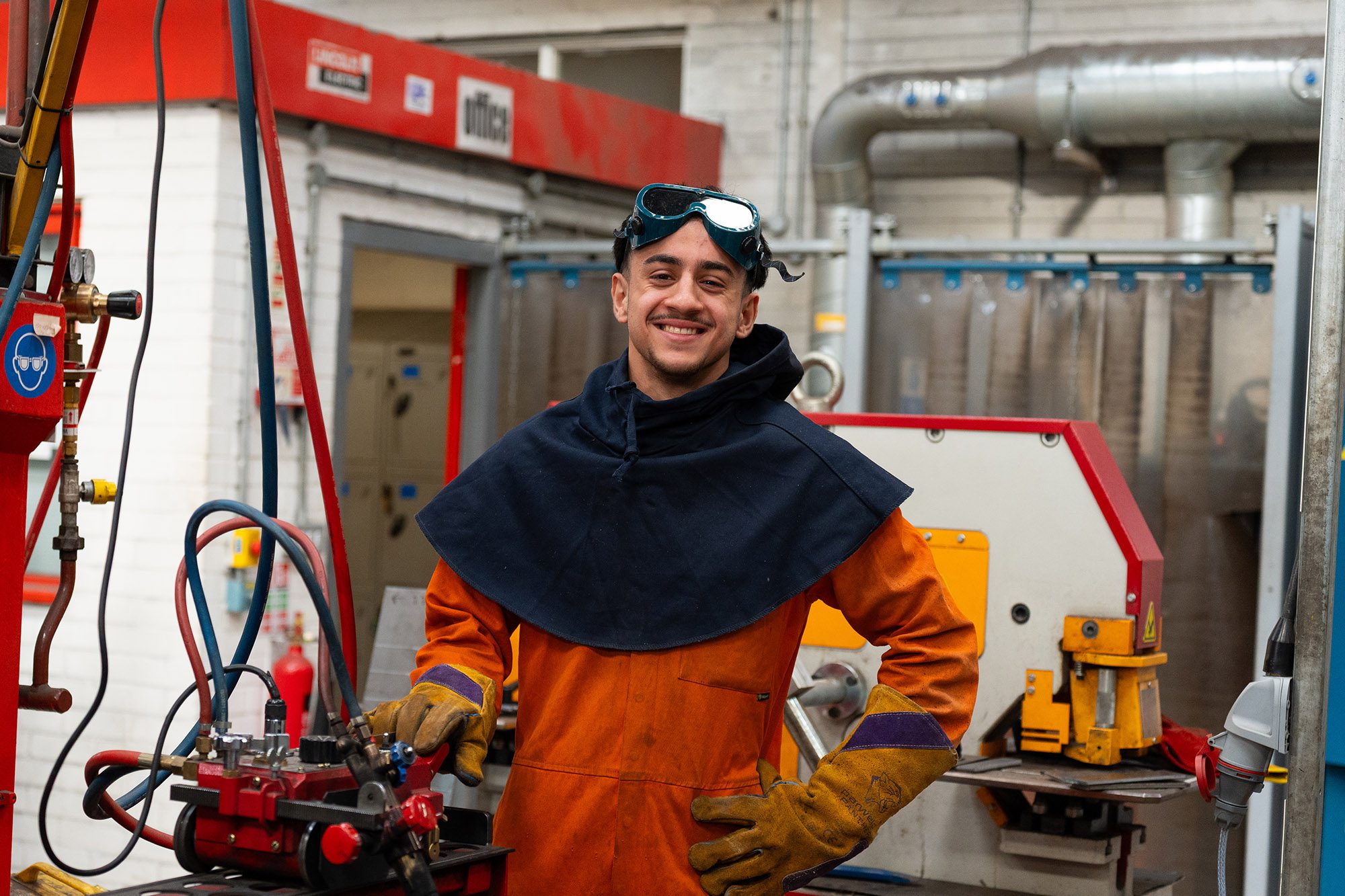 Engineering student using welding machinery