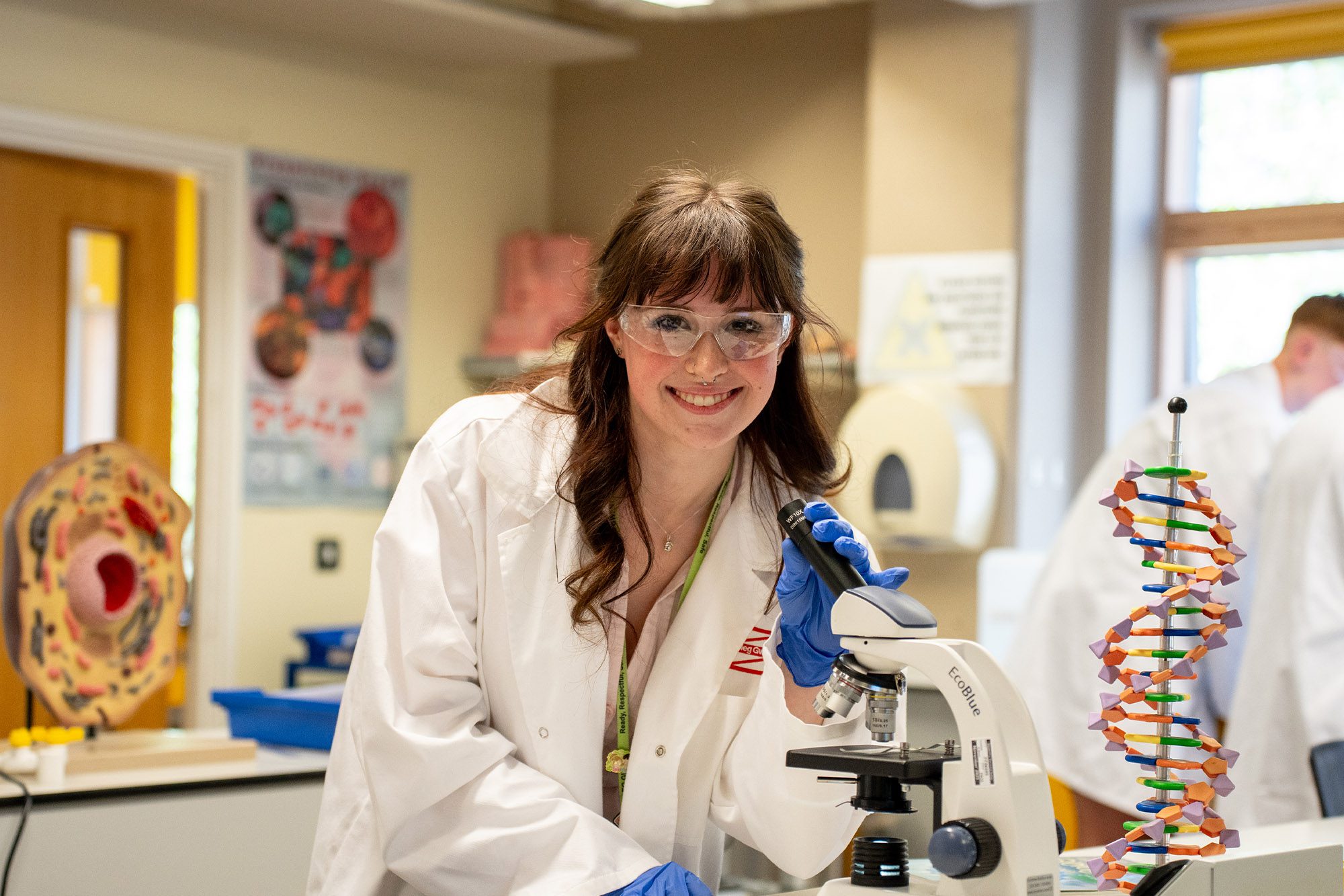Science student using a microscope in the lab