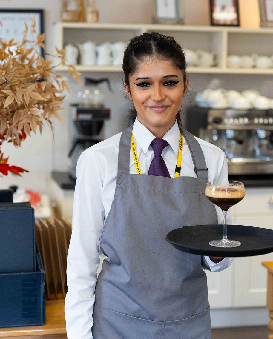 Student with drink at Morels Restaurant
