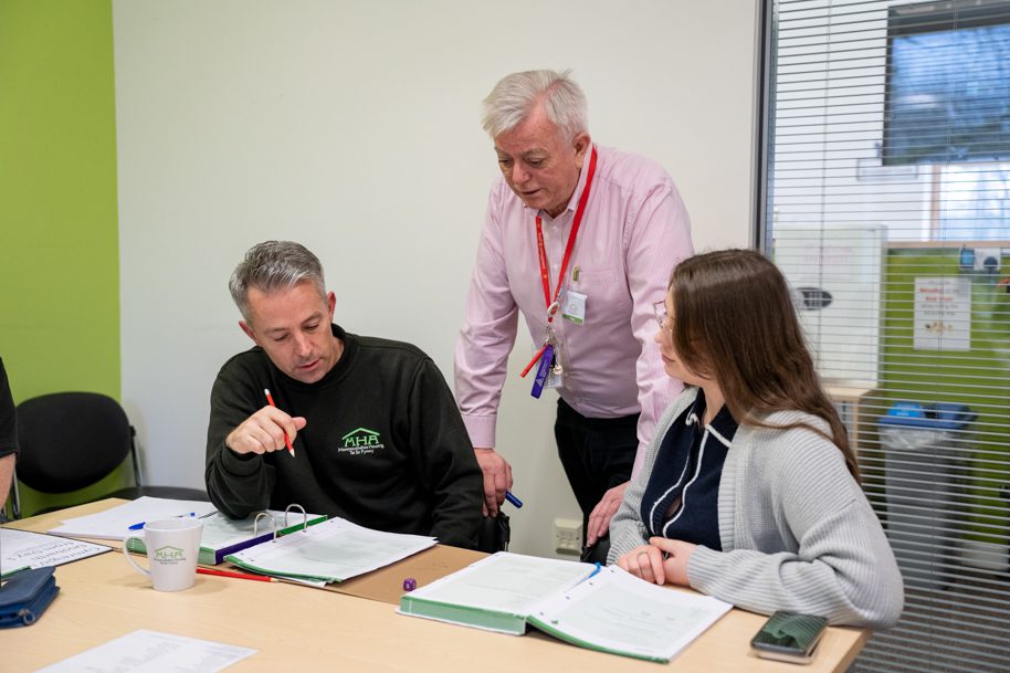 Adults with tutor learning Welsh at work