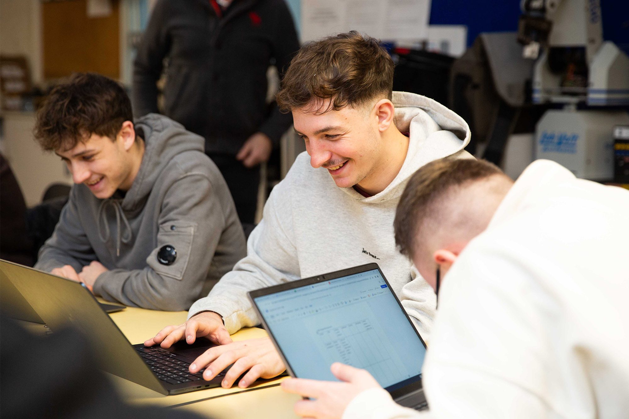 CG learners laughing together in a group.