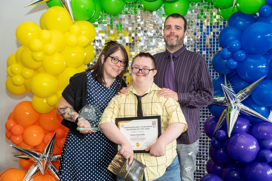 Adult learners holding an award