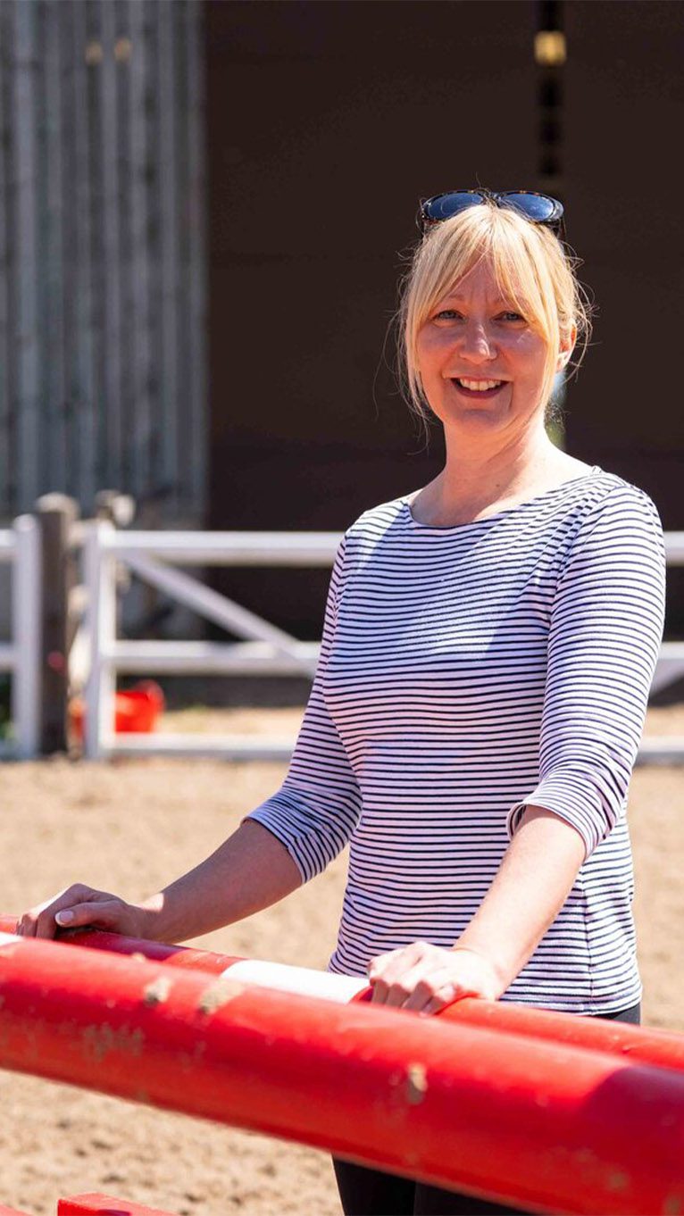 Student standing in the sun at the equestrian centre